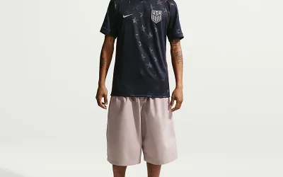 Men wearing Nike USA 2026 World Cup away jersey with beige shorts and sneakers, modern soccer streetwear outfit for casual summer fashion