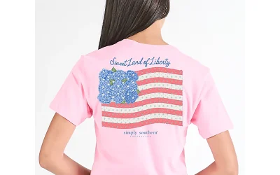 Woman wearing Simply Southern Liberty short sleeve graphic T-shirt in light pink with casual summer patriotic outfit styling