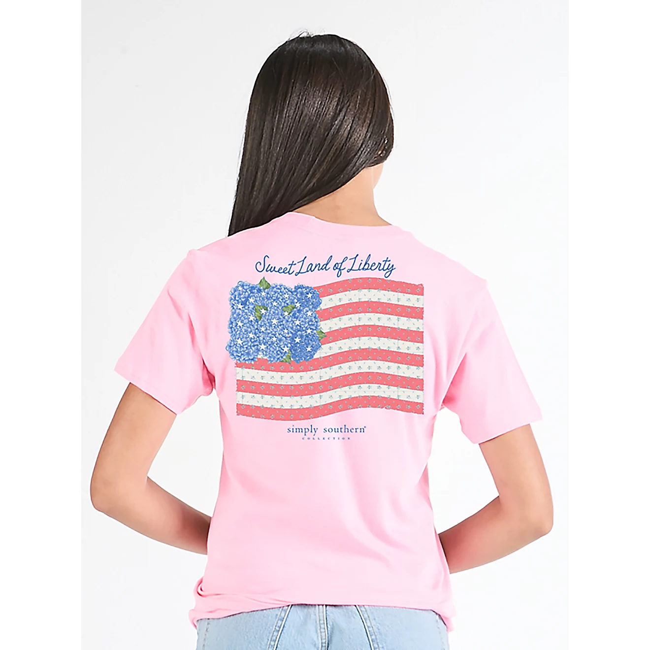Woman wearing Simply Southern Liberty short sleeve graphic T-shirt in light pink with casual summer patriotic outfit styling