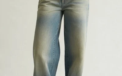 Woman wearing PacSun Casey low rise baggy jeans in tinted light blue with oversized casual Y2K streetwear outfit